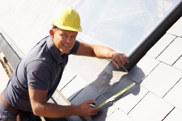 roofer fixing roof tiles